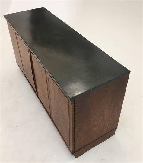 Built on an unique aluminum frame that provides a strong and flexible platform. Diminutive Slate and Walnut Console Cabinet with Low ...