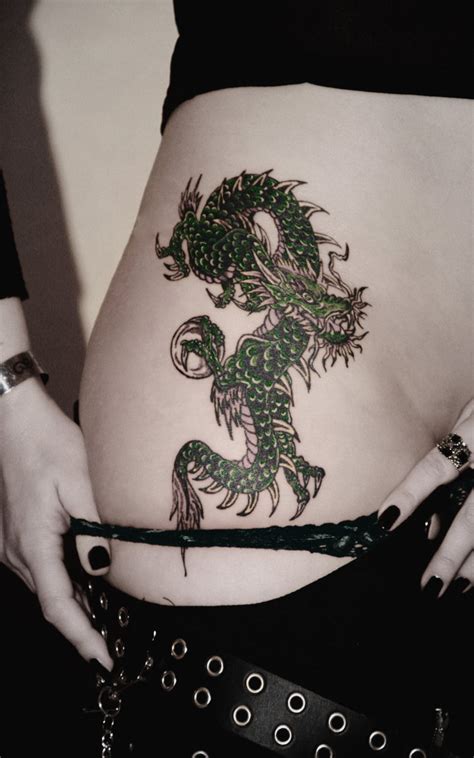 Feminine dragon tattoo with flowers. Women Dragon Tattoos