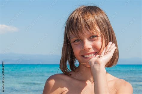 Young Girl Looking For Seashells At The Beach Stock Photo Adobe Stock
