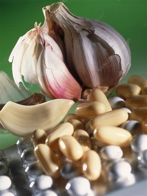 A garlic clove is the single part of the garlic bulb that is covered in paper skin. Garlic cloves and pills containing garlic oil - Stock ...