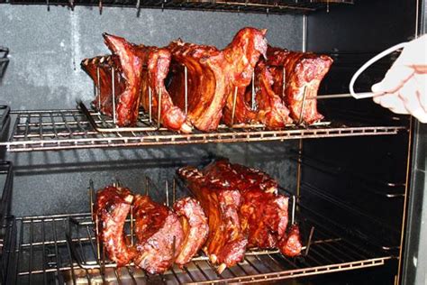 One jerky rack, two regular racks, and a water pan are inside behind the attractive stainless steel door. Camp Chef SMV-18 Smoke Vault Smoker with Stainless Steel Doors