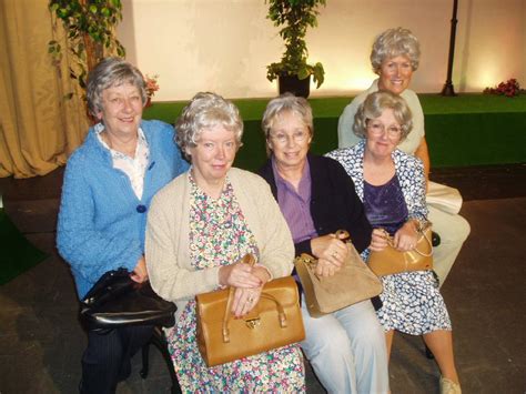 Happy older woman laughing by gray wall. Five Blue Haired ladies Gallery - Bebington Dramatic Society