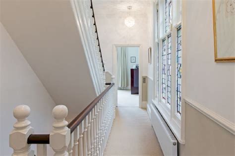 Entrance hall design includes a bespoke wool stair runner with bespoke stair rods, custom panelling, radiator covers and we designed all the interior doors the herringbone floor and statement lighting give this home a modern edge, whilst its use of neutral colours ensures it is inviting and timeless. Wide entrance hall, stairs and landings in modernised Victorian house. | Contemporary home decor ...