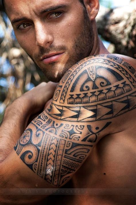 An ouroboros dragon tattoo with the tree of life in the center of the design. Amazing eyes men's tribal tattoo on arm - | TattooMagz ...