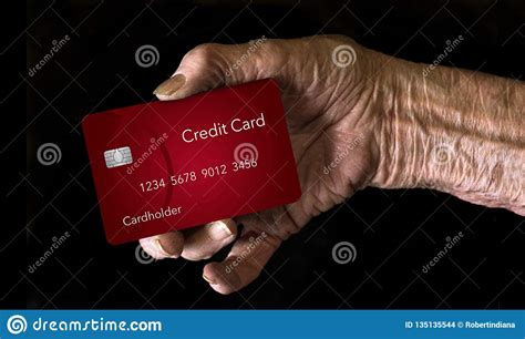 While in 2001 about a quarter of senior households held credit card balances, by 2016, that number rose to 34%, according to the national council on aging. An Elderly Hand Holds A Credit Card To Illustrate The ...