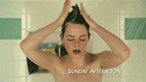 Pregnant mom breast feeds toddler while doing hair. Shower Animated GIF
