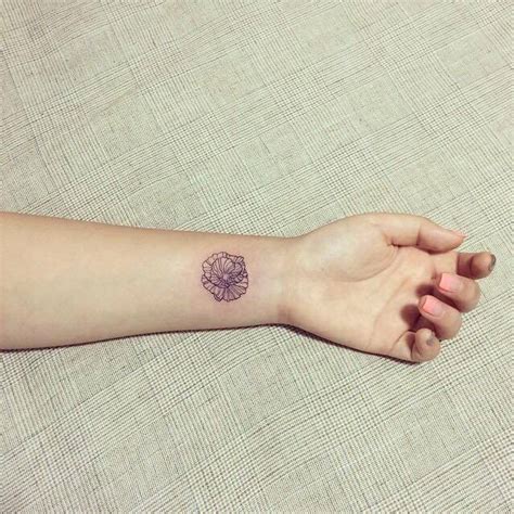 Depending on your wishes you can make a simple black or funny colorful one and pick up interesting and great accessories for them such as rings and bracelets. Poppy tattoo on the left inner wrist.