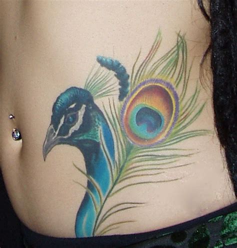 If you place a tattoo on the side of your stomach (above the hip bone), you're getting a side stomach tattoo. 25 Sexy Lower Stomach Tattoos for Women | Feather tattoos ...