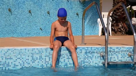 I have a good eye for talent and think he needs a new job. Boy Is Sitting On The Edge Of The Pool Wetting Feet In ...