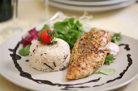 Move cooked chicken into container, and add raw chicken to the dish for round two. Broiled Chicken Breast With Wild Rice Stock Image - Image ...