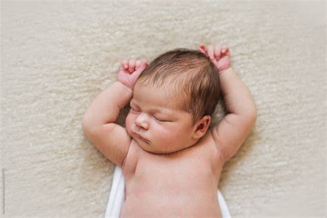 A Relaxed Newborn Baby Sleeping by Lea Csontos