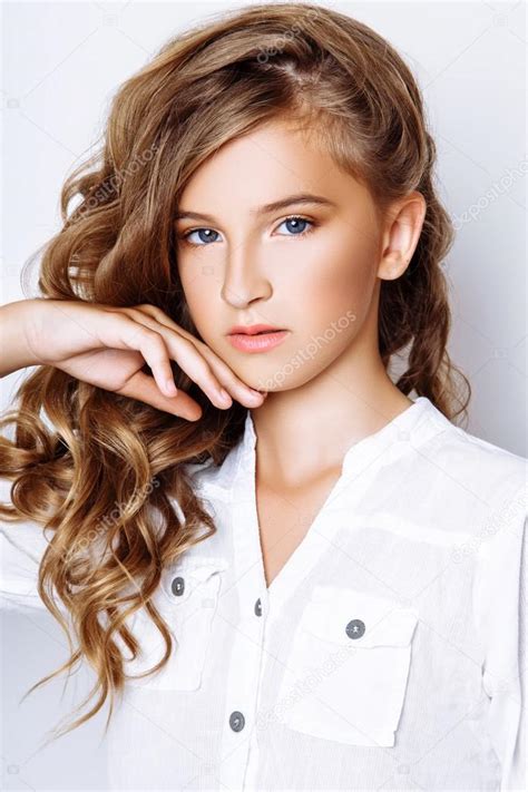 This website requires you to be 21 years of age or older. A beautiful blond-haired 13-years old girl in studio on ...