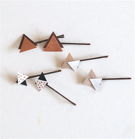 The tutorial is found at think bowtique. DIY Wooden Triangle Hair Pins - The Merrythought