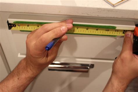 You can prevent that tear out by placing painter's tape over the spot, or placing a scrap piece of wood behind the cabinet as you drill. How to Install Cabinet Hardware: Install Cabinet Knobs ...