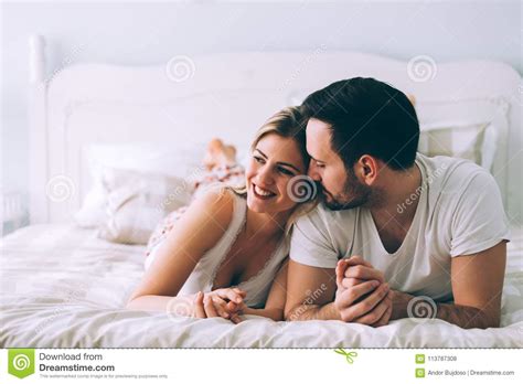 Portrait Of Young Loving Couple In Bedroom Stock Photo - Image of couple, beautiful: 113787308