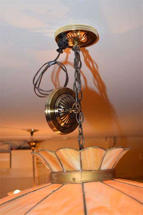 Lift the light fixture off the mounting bracket and let it hang (or get a friend to help hold the fixture if it's heavy.) remove the wire nuts and untwist the wire connections. Hanging Light Fixture | Gates Antiques Ltd. | Richmond, VA