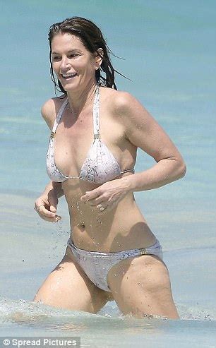 I've still not seen any. Cindy Crawford wows in white snakeskin bikini in St Barths ...