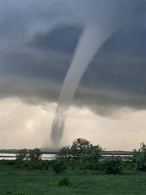 A tornado is a violently rotating column of air extending from the base of a thunderstorm down to the ground. Eyewitnesses film tornado in Kherson region