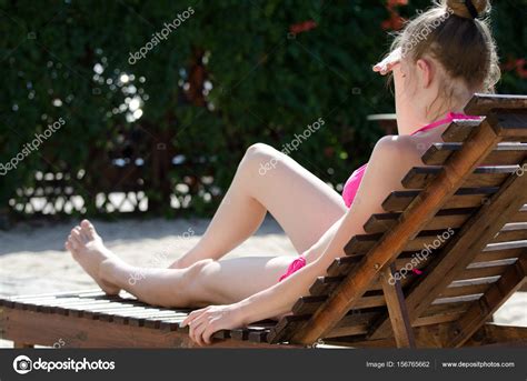 Kada love masturbates in the sun selfmade great pussy. Girl in a swimsuit on a deckchair in the backyard — Stock ...