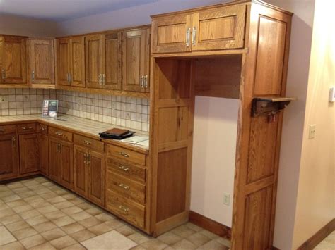 White with tan glaze refinished cabinets & black island and barstools. Pickled Cabinets Refinishing / Cabinet refinishing is in ...