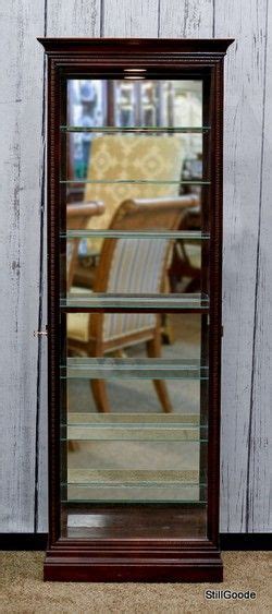Cabinet is illuminated by an interior light. Howard Miller lighted curio cabinet with 2 side entry ...