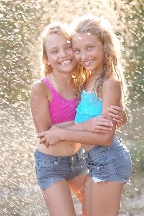 One misconception is that the crown is loose. Portrait of two girls of girlfriends on a summer nature ...