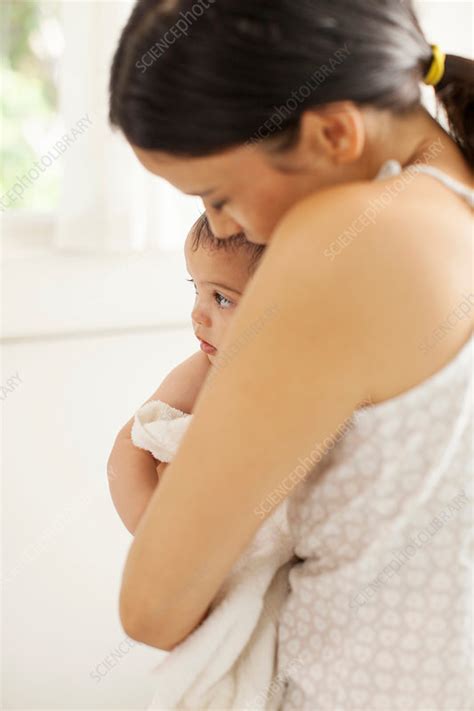 During the 4 month fussy phase, both you and your baby are likely exhausted so extra snuggles, cuddles and soothing words go a long way. Mother drying off baby girl after bath - Stock Image ...