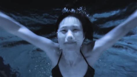 And a guy can be beautiful too! Beautiful Asian woman swimming underwater in pool at night ...