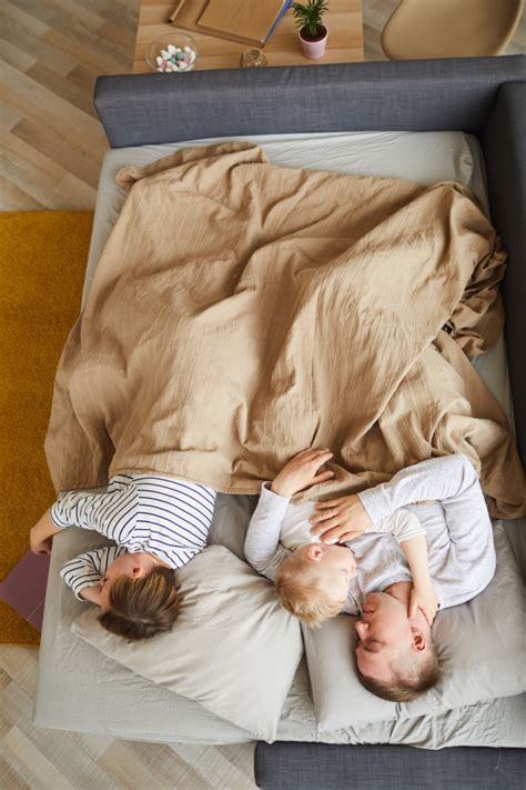 Add to compare compare now. Family sleeping on sofa bed | Premium Photo