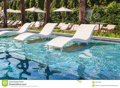 Showing results for in water pool chairs. Chaise Lounge In Swimming Pool Stock Photo - Image of ...