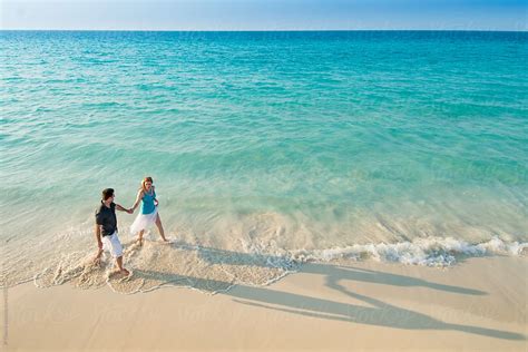 "Aerial View Of Romantic Couple Walking Along Tropical Caribbean Beach ...