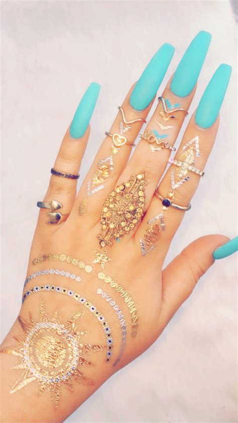 The tattoos are generally an intricate design. Quartz 💅🏼 | Hand henna, Foil tattoo, Hand tattoos