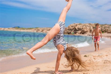 Nylon was invented in 1938 as a cheaper alternative to silk stockings and has been an object of male obsession ever since. Adorable little girl making wheel on tropical white sandy ...