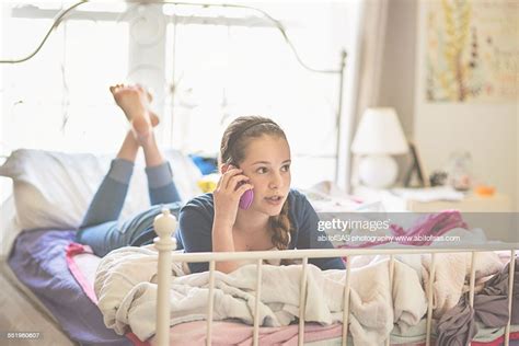 I forgot how gravity works and took a sip expecting it to work the same as when sitting…my nose did not appreciate it…neither did my sofa. Teen Girl Laying On Bed Talking On Phone Stock Photo ...