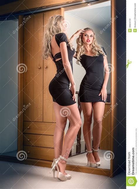 Select from premium woman looking in mirror face of the highest quality. Young Woman Looking In Mirror Stock Image - Image of ...