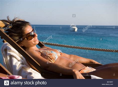 Vintage aluminum webbed folding lawn lounge chair beach sun terrace multi color. Two women sitting in deck-chairs on terrace of the Goya Beach Bar Stock Photo: 29490811 - Alamy