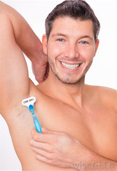 Bearded hipster man shaves his armpit with a razor. What Are the Best Tips for Men Shaving Their Armpits?