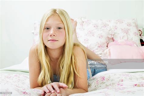 David prado / addictive creative; Preteen Girl Laying On Bed High-Res Stock Photo - Getty Images