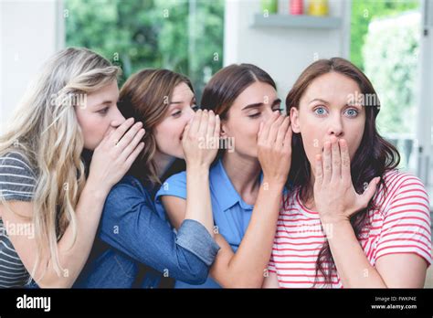Women in a row whispering secrets in their friends ears Stock Photo ...