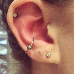 Inner conch piercing and outer conch piercing. orbital cartilage piercing