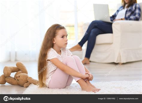 Sad little girl sitting on floor in room ⬇ Stock Photo, Image by ...