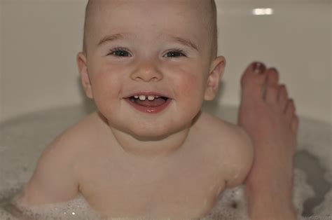 Newborn baby bath tubs eliminate the need to bend down and hurt your back. Smiling Baby In Bath Tub