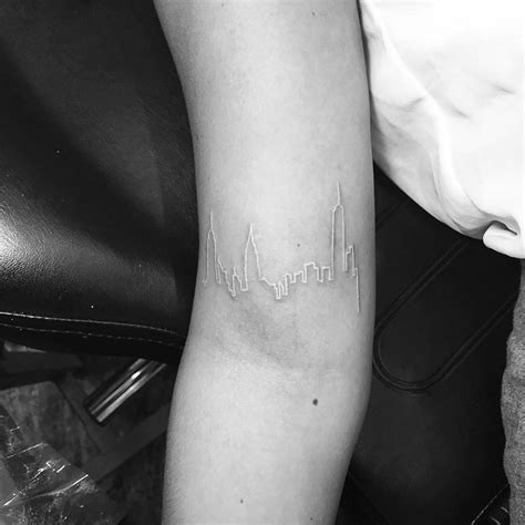 Back to black ink home. White ink tattoo of the skyline of New York on the