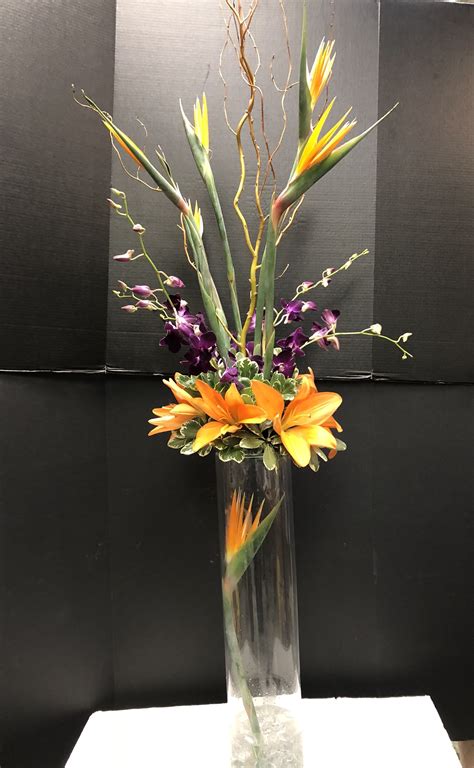 They're an easy way to add height to candles, and stacks of classics can effortlessly fill out the center of a table. Rehearsal dinner centerpiece - birds of paradise, curly ...