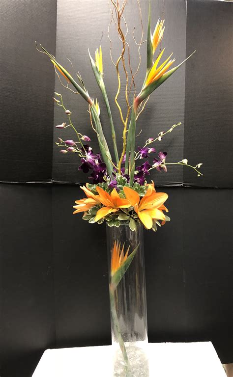 It's almost the big day and it's time for one last get together! Rehearsal dinner centerpiece - birds of paradise, curly ...