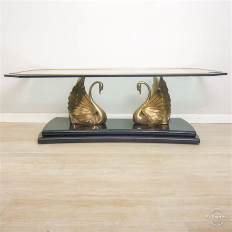 Contemporary brass coffee table with two tiers, each tier having an inset glass top. 1970s Hollywood Regency Brass Swan Glass Top Coffee Table ...