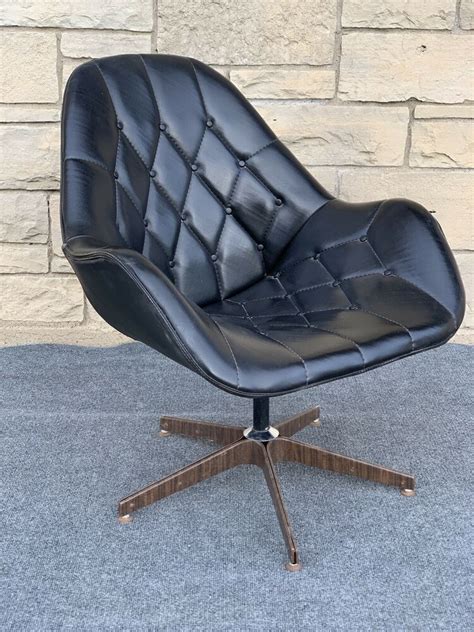 Its flat top back curves around a removable circular seat. Mid Century Modern Tufted Black Vinyl Swivel Egg Pod ...