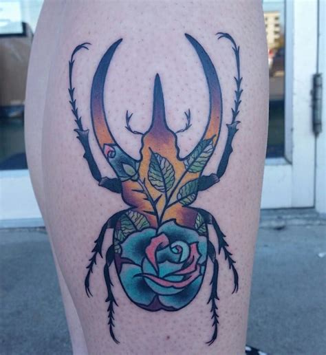 This is a fantastic tattoo and piercing shop. Beetle silhouette filled with roses, concept designed by ...