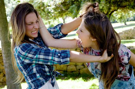 A friend is someone who knows all about you and still loves you. ― elbert hubbard. Two Teenager Friends Fighting In Park Angry Pulling Long ...