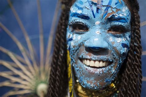 A reveler dressed as a character from the movie 'Avatar' poses for a ...